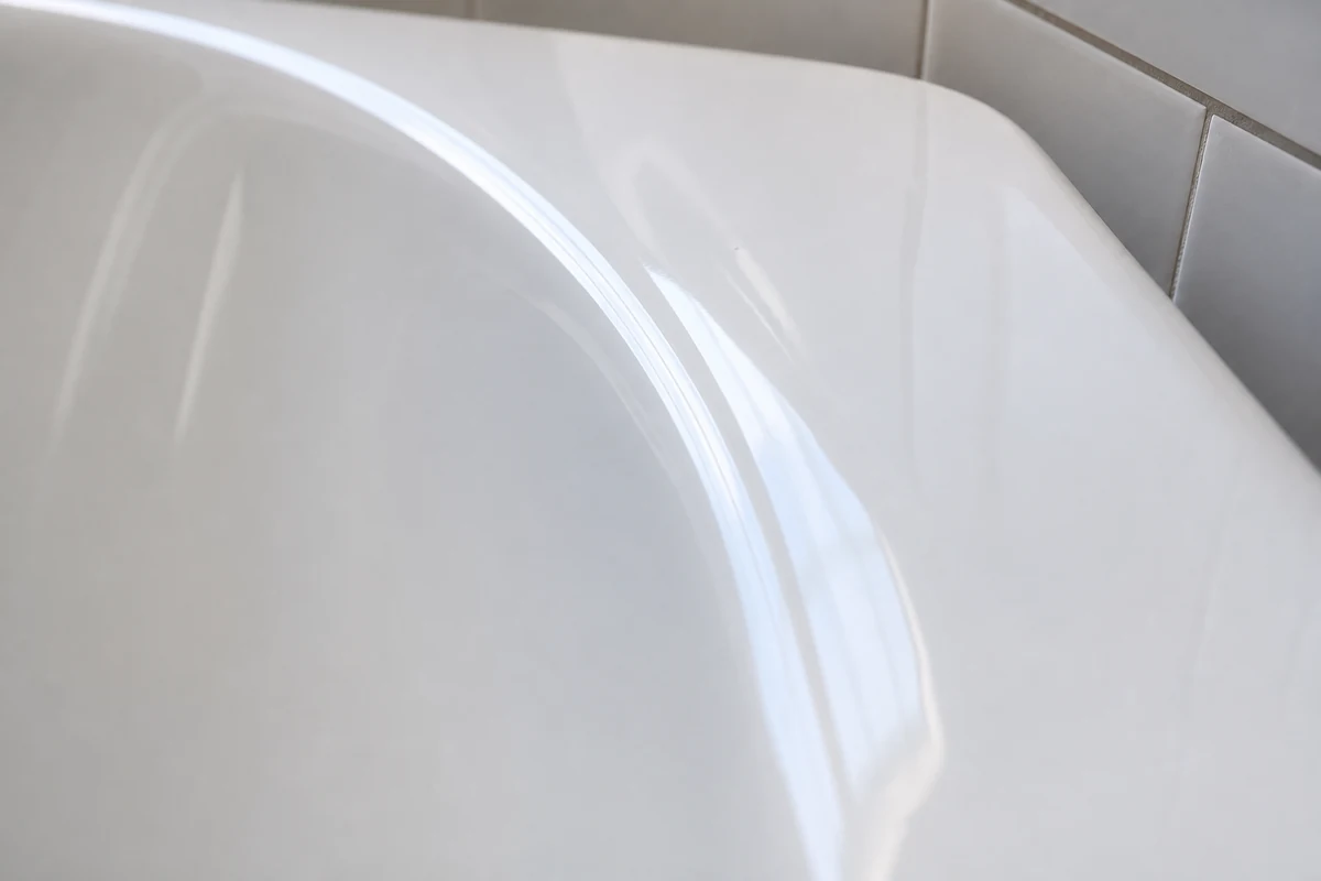 Glossy reglazed white bathtub finish years after refinishing in an Oakland home